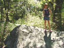 Katelyn standing on rock with Indian markings